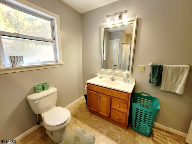 bathroom featuring toilet and vanity