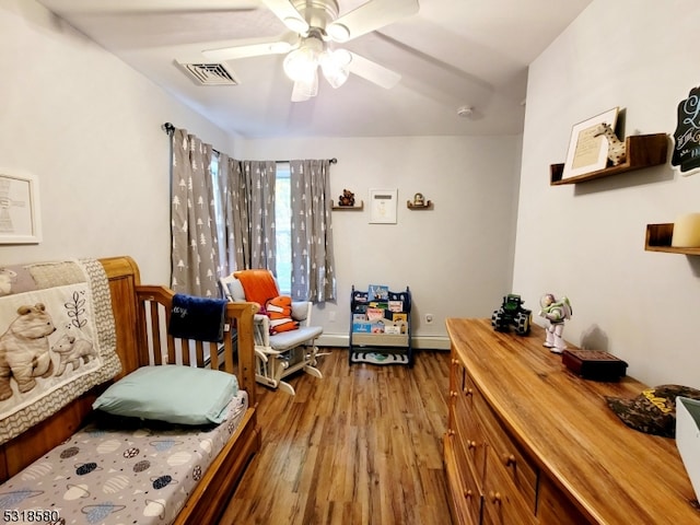 living area featuring hardwood / wood-style flooring and ceiling fan