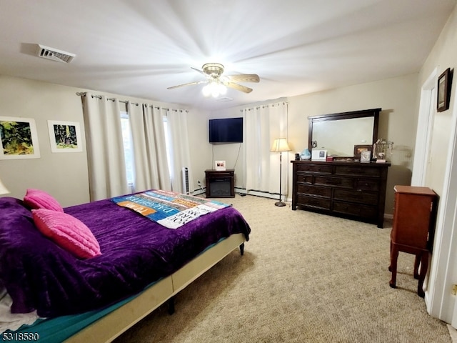 carpeted bedroom with baseboard heating and ceiling fan