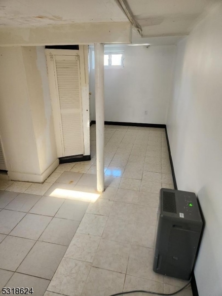 basement featuring light tile patterned flooring