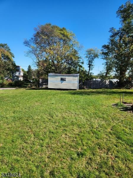 46 Highland Ave, Morris Twp, NJ 07960 - view of yard featuring a storage shed, an outdoor structure, and fence