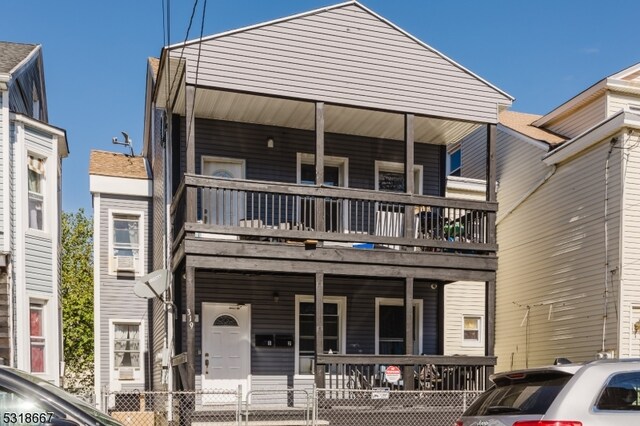 view of front of property with a porch and a balcony