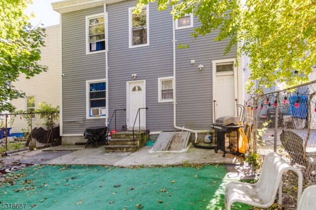 rear view of property featuring cooling unit