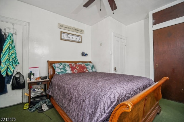 bedroom featuring ceiling fan and dark carpet