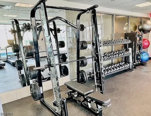 workout area featuring a drop ceiling