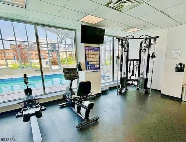 exercise room with a drop ceiling