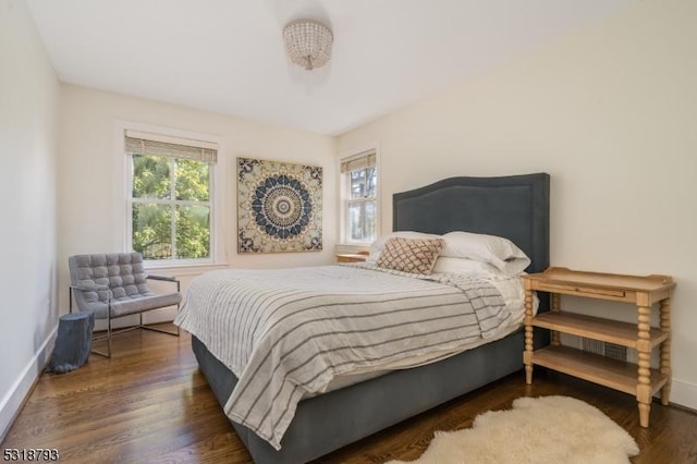 bedroom featuring wood finished floors and baseboards