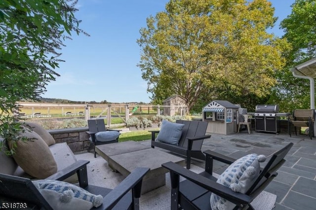 view of patio with grilling area, outdoor lounge area, and an outbuilding