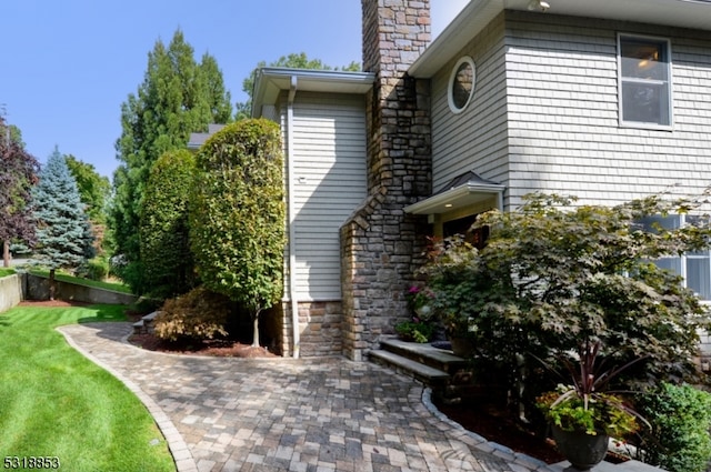 view of property exterior featuring a lawn