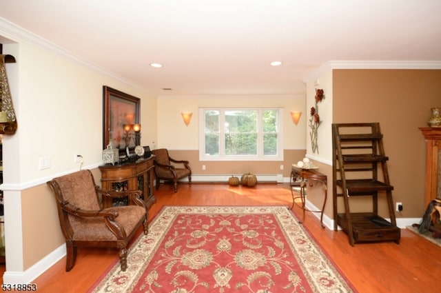 living area with wood-type flooring, crown molding, and baseboard heating