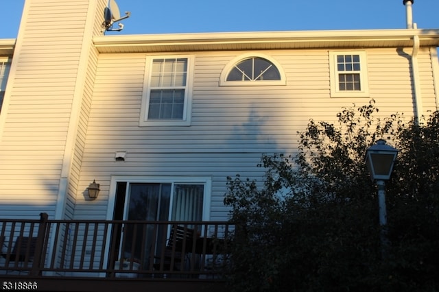 view of home's exterior with a wooden deck