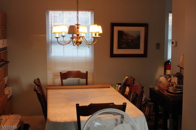 dining space with an inviting chandelier