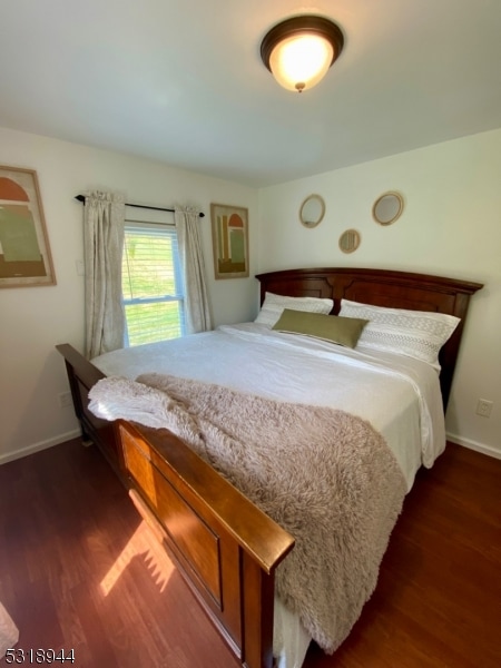 unfurnished bedroom featuring dark wood-type flooring