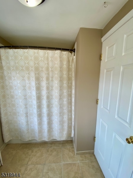 bathroom with a shower with shower curtain