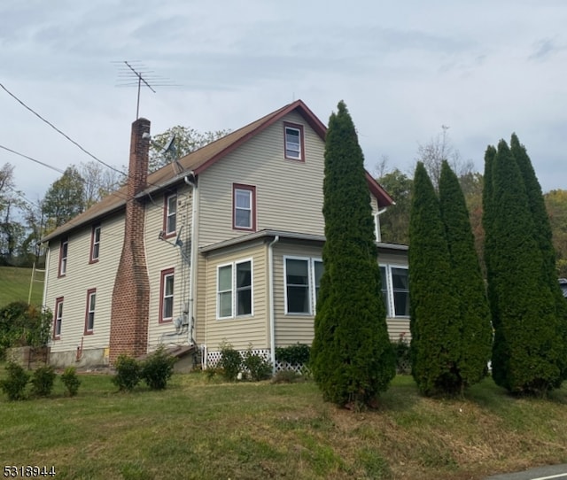 rear view of house with a lawn