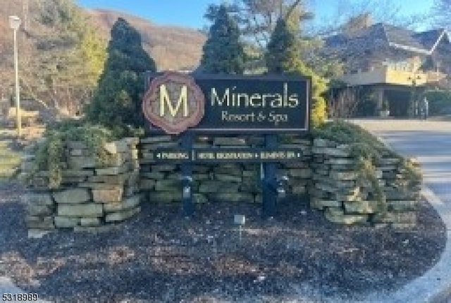 community / neighborhood sign with a mountain view