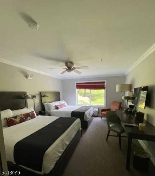 bedroom featuring ceiling fan, crown molding, and carpet flooring