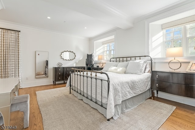 bedroom with light hardwood / wood-style flooring and crown molding