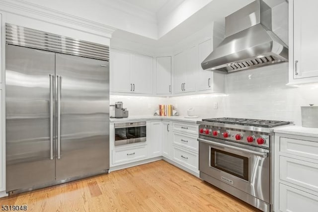 80 Claremont Rd Unit 802, Bernardsville Boro, NJ 07924 - kitchen featuring white cabinets, light countertops, backsplash, wall chimney range hood, and high quality appliances