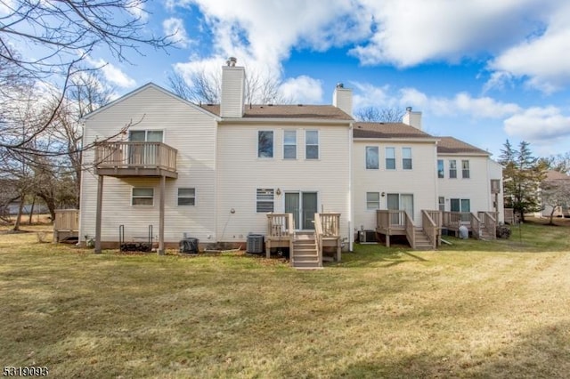 rear view of property with cooling unit and a lawn