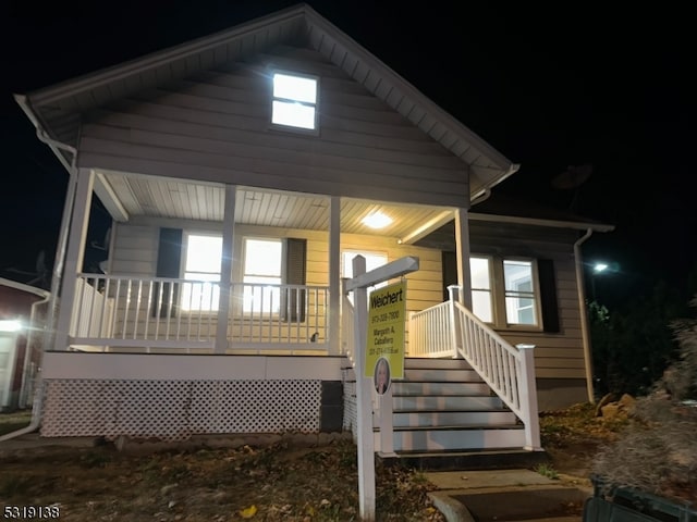 back house at night with covered porch