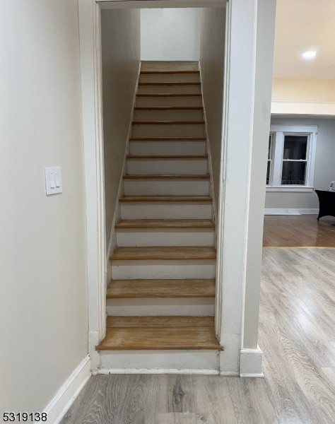 stairway featuring hardwood / wood-style flooring