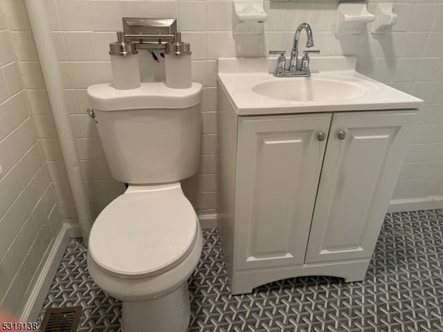 bathroom featuring vanity, tile walls, and tile patterned flooring