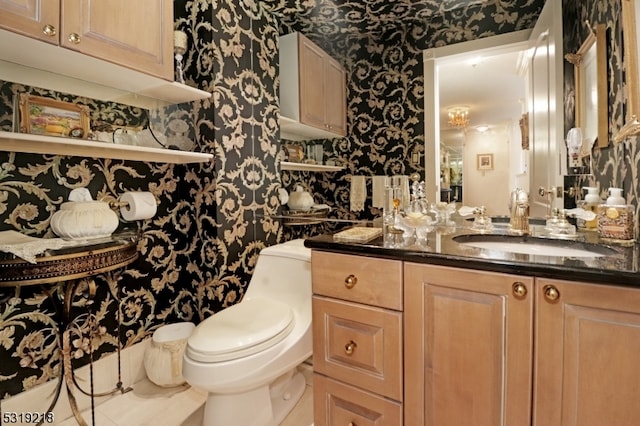 bathroom featuring vanity, toilet, and tile patterned floors