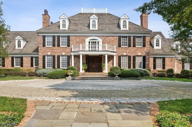 3 Winston Farm Ln, Mendham Twp, NJ 07931 - georgian-style home featuring a balcony, brick siding, and a chimney