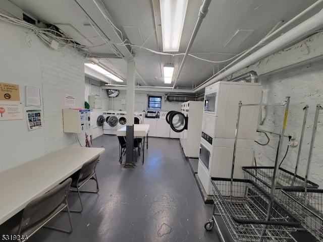 interior space with stacked washer and dryer and washer and clothes dryer