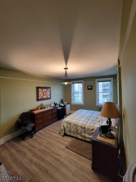 bedroom with hardwood / wood-style floors