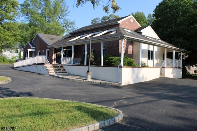 country-style home featuring covered porch