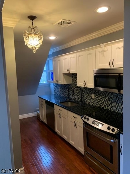 kitchen with sink, white cabinetry, stainless steel appliances, and dark hardwood / wood-style flooring