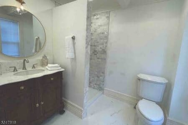 bathroom with vanity, toilet, and walk in shower