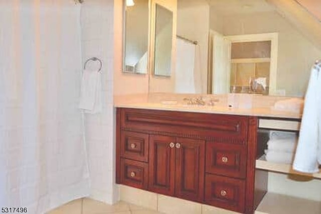 bathroom with vanity, tile patterned floors, and curtained shower