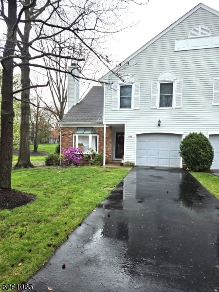 view of front of house featuring a front yard and a garage