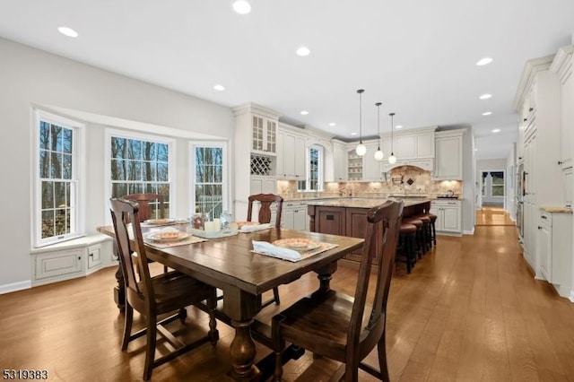 dining room with wood finished floors and recessed lighting