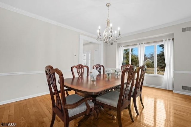 dining area with light wood-type flooring, visible vents, and crown molding