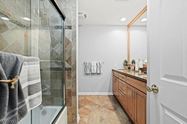 bathroom featuring double vanity, baseboards, bath / shower combo with glass door, a sink, and recessed lighting