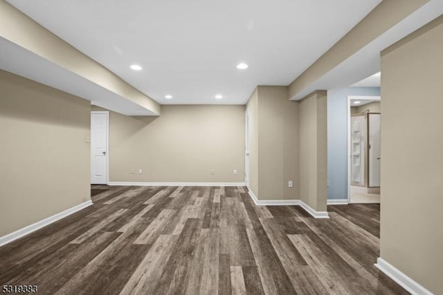 finished basement with dark wood finished floors and baseboards