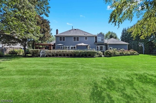 rear view of property with a yard