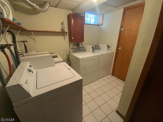 washroom with light tile patterned flooring and washing machine and dryer