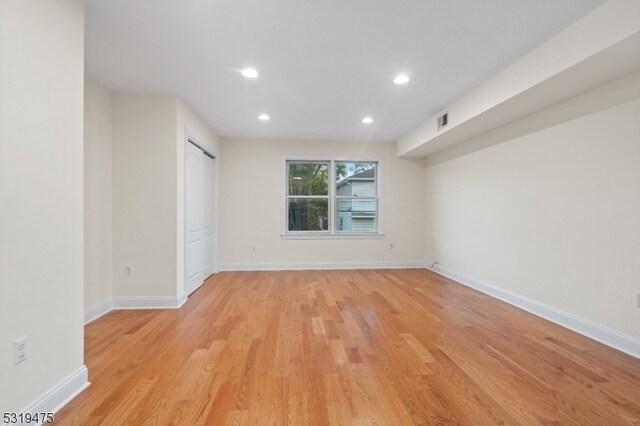 unfurnished room with light wood-type flooring