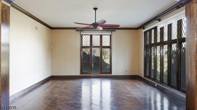 spare room with crown molding, dark hardwood / wood-style floors, and ceiling fan