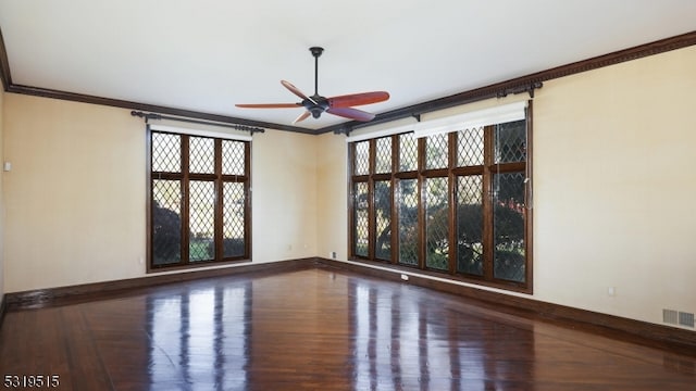 empty room featuring ornamental molding, hardwood / wood-style floors, and ceiling fan