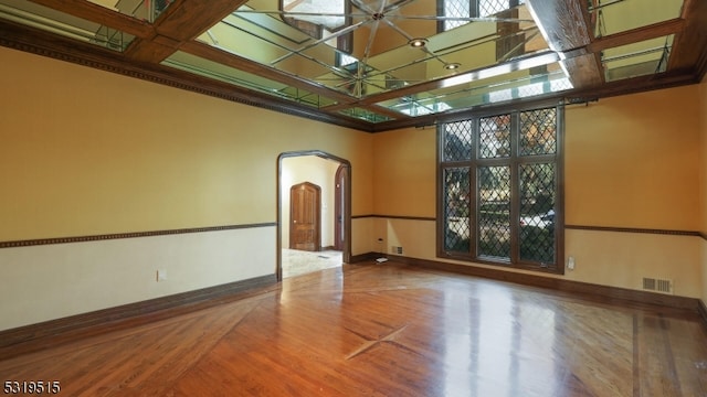 spare room featuring hardwood / wood-style floors and coffered ceiling