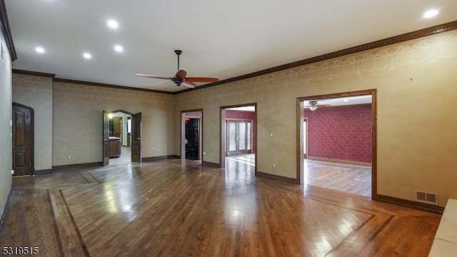 unfurnished living room featuring ornamental molding, ceiling fan, and dark hardwood / wood-style flooring