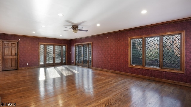 interior space with french doors, crown molding, wood-type flooring, and ceiling fan