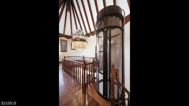 hallway with a notable chandelier and dark wood-type flooring