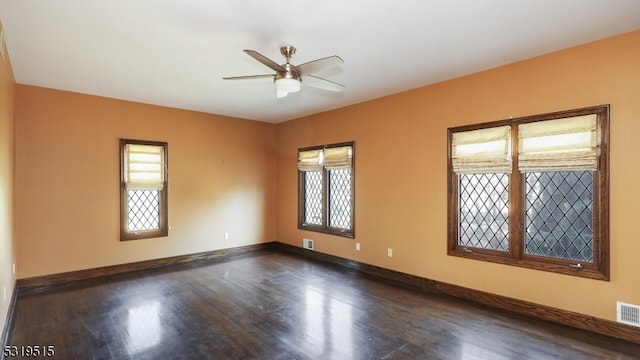 unfurnished room featuring dark wood-type flooring and ceiling fan